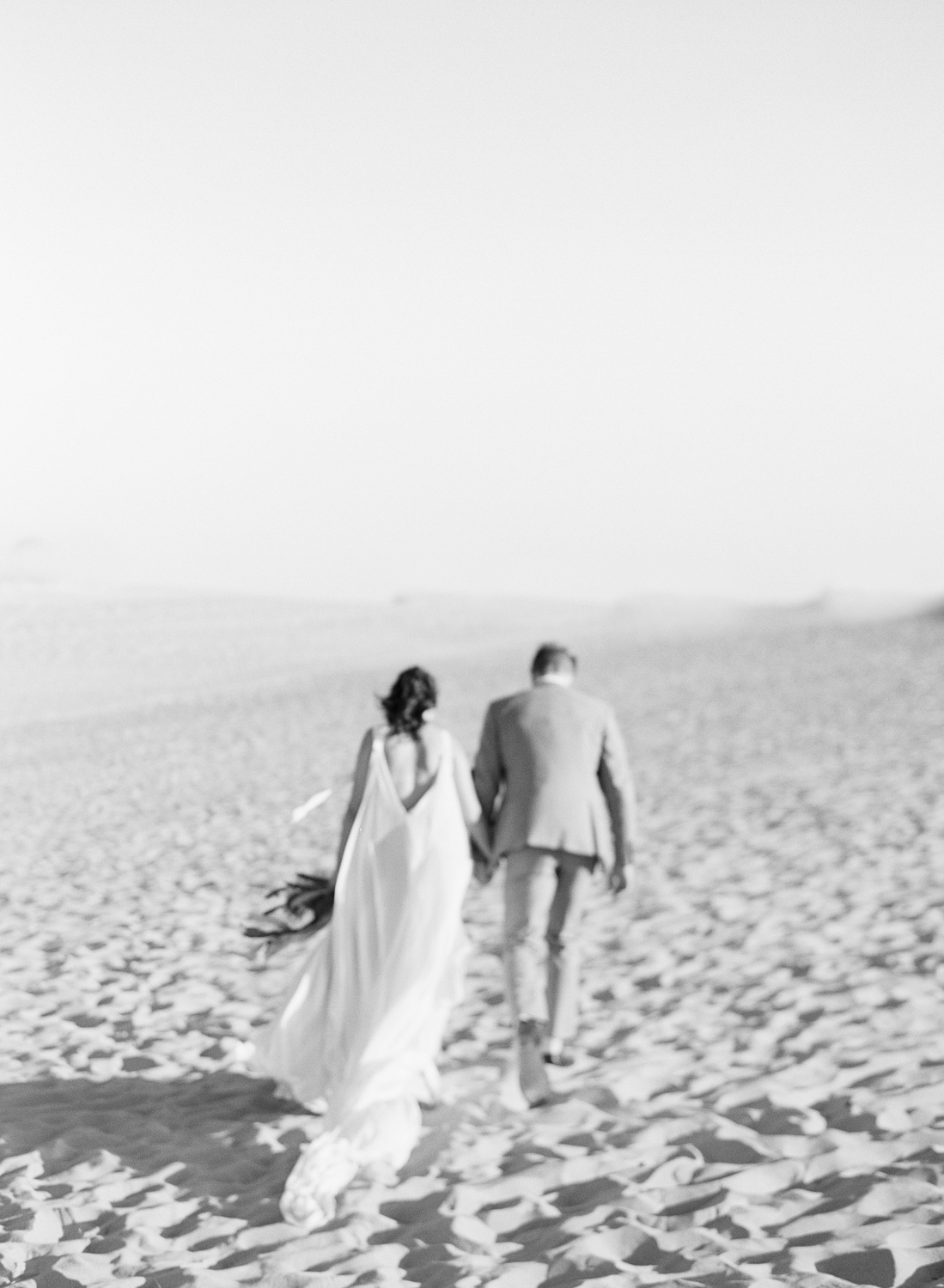 Just married couple walking on the beach